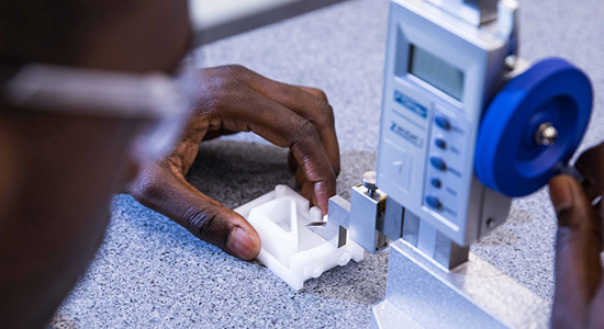 measuring injection molded part in metrology lab