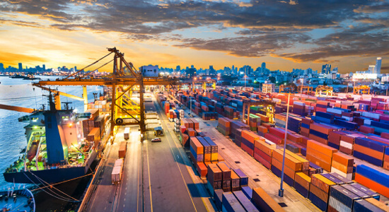 Cargo ships loading at a port