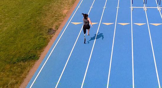 Woman running on a blue track