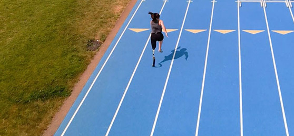 Woman running on a blue track